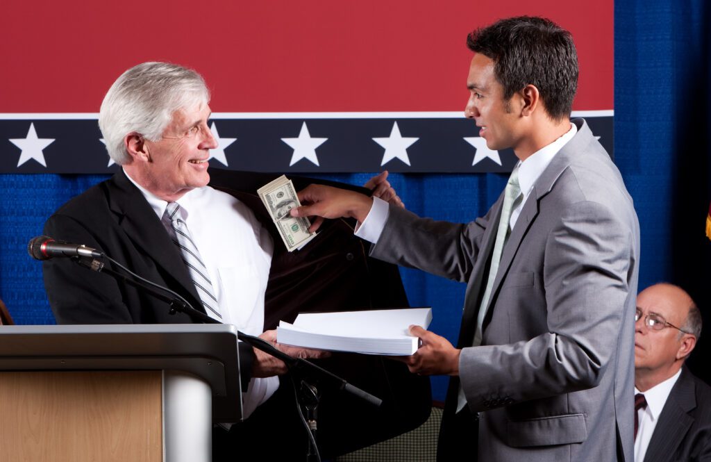 Two men exchanging money at podium.